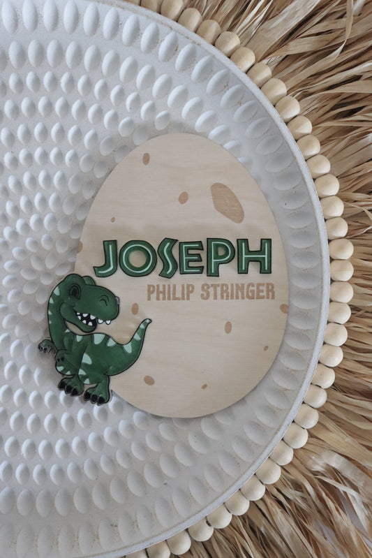 Decorative plate with a name and character design on a wood surface