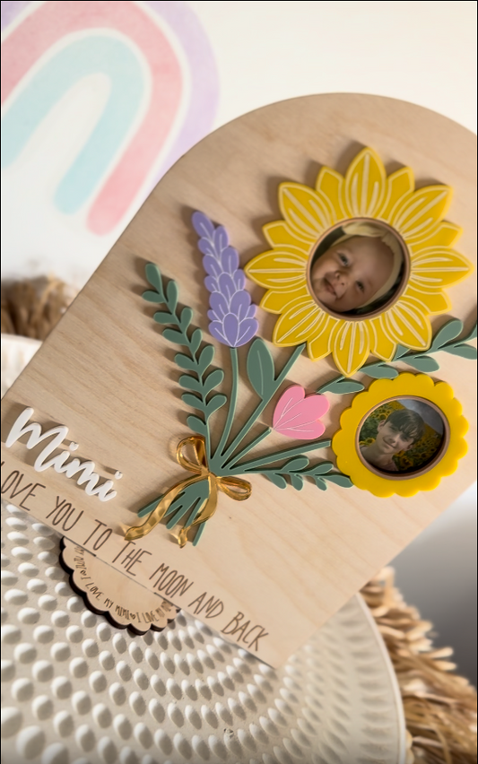 a personalised wooden plaque with sunflowers, lavender and leaves displaying two children with engraved script