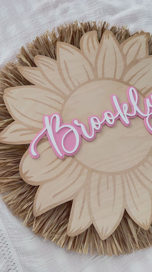 Video of wooden sunflower name sign with Brooklyn. Natural wood